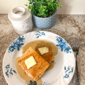 baking sheet pancakes served with butter and maple syrup