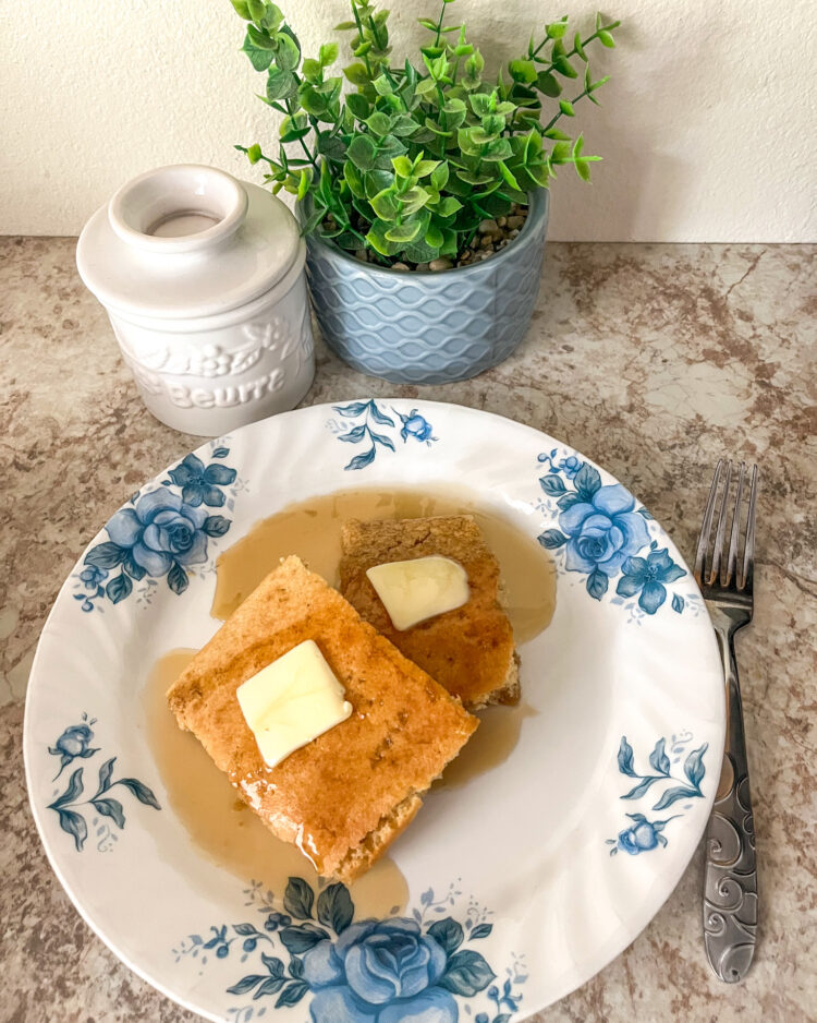 baking sheet pancakes served with butter and maple syrup