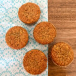einkorn banana muffins on turquoise patterned placemat