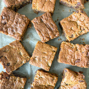 Einkorn chocolate cookie bars titled sideways on parchment paper.