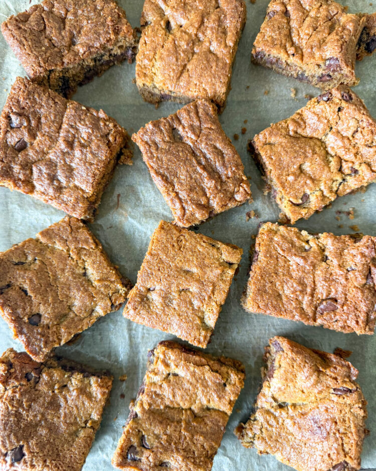 Einkorn chocolate cookie bars titled sideways on parchment paper.
