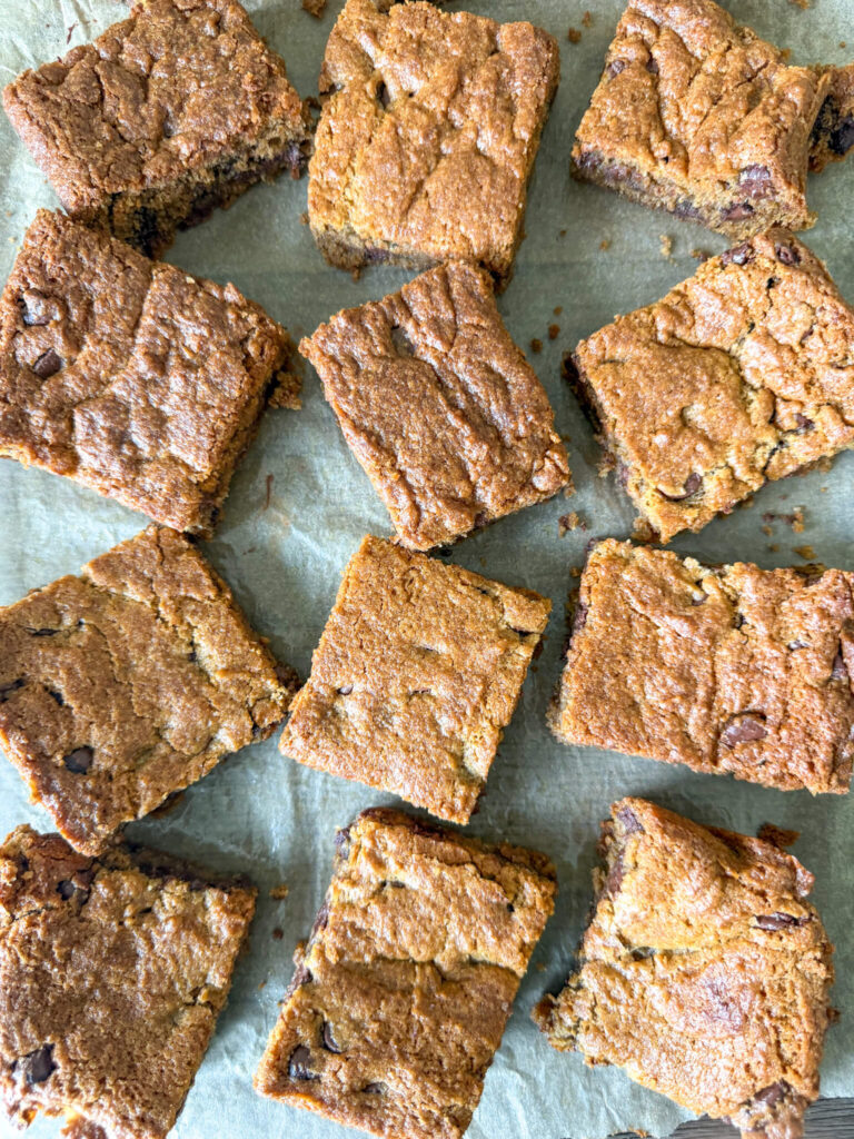 Einkorn chocolate cookie bars titled sideways on parchment paper.